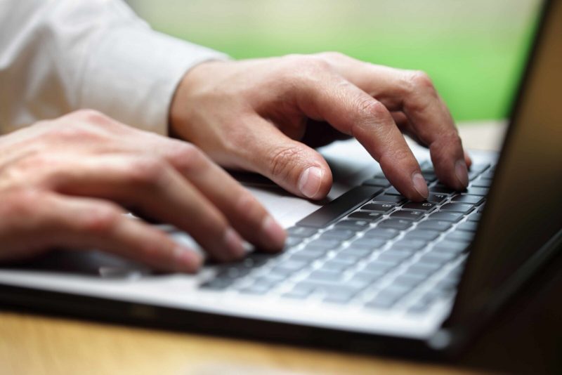 employee typing on laptop, retain IT staff by offering avenues to attain new skills and advance