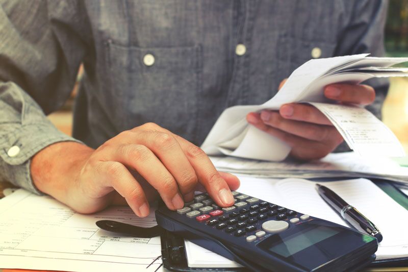 man doing payment calculations, fair pay for contingent faculty